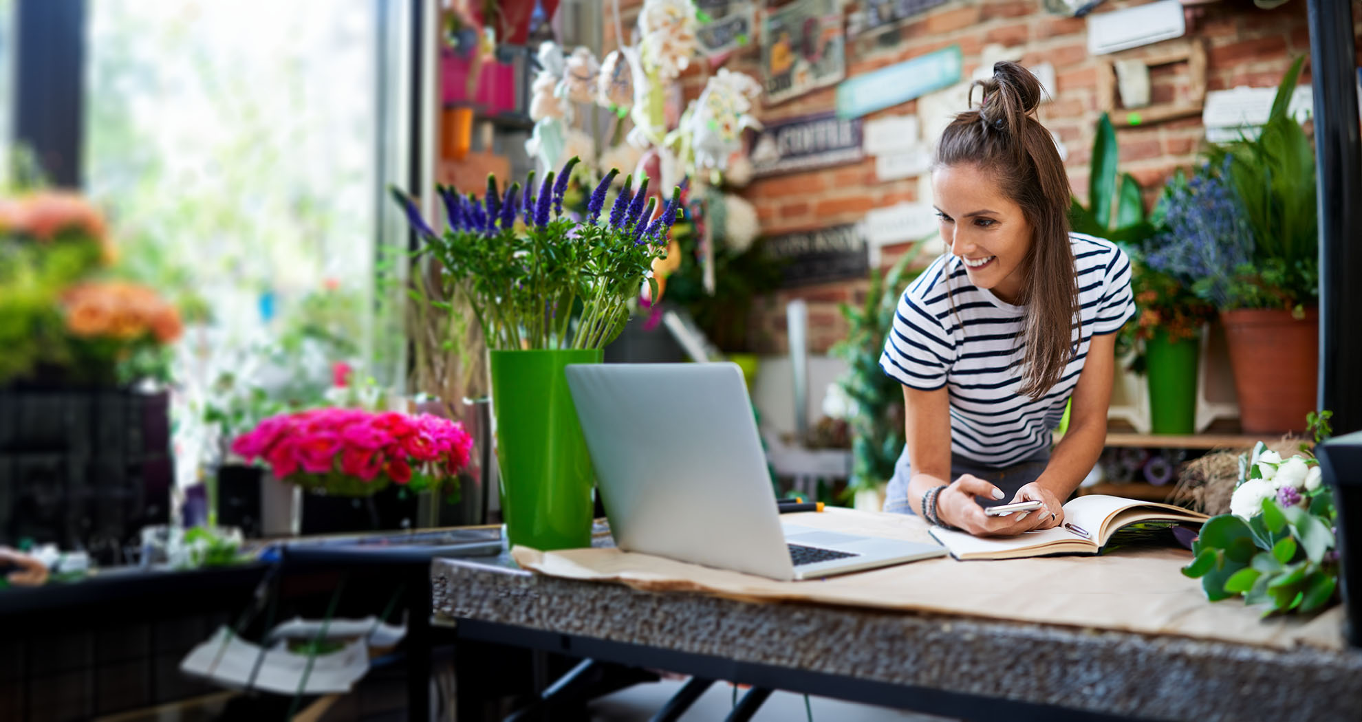 Woman in green jumper looking at phone