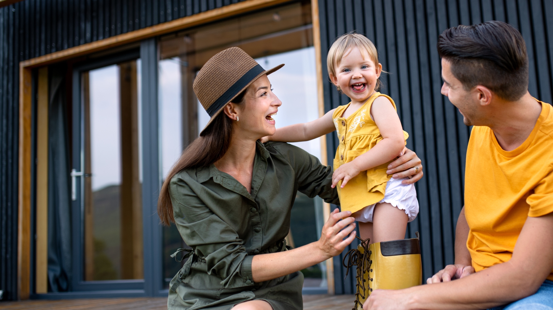 Couple wit a child outside there house