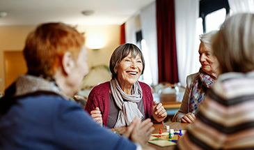 Group of friends sitting round a table in a nursing home
