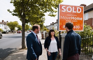 Couple standing outside new home